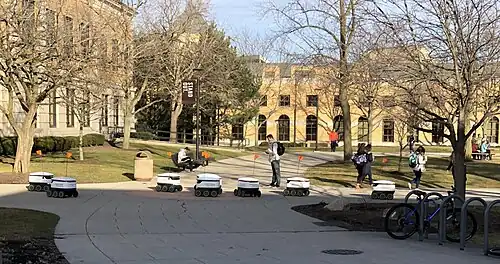 Delivery robots causing a pileup after failing to navigate past each other.