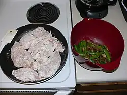 6. Remove mushrooms/peas from heat, and put floured chicken in frying pan.