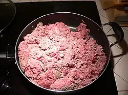 Adding the beef to the pan