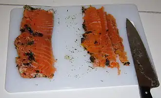 Serve thin slices of the cured salmon.