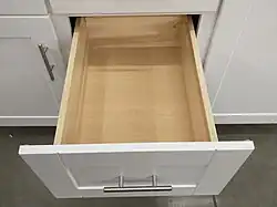 framed base cabinet with open drawer