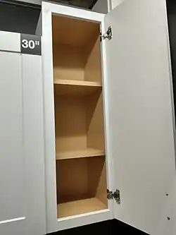 framed wall cabinet with shelves behind a door