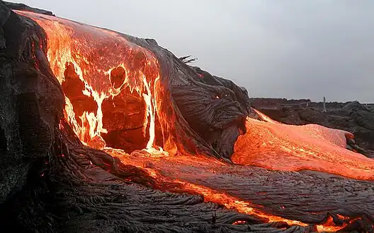 Molten lava flowing onto a beach, a fitting inspiration for a fire type Pokémon.