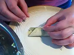 Step 4: Bring the sides of the wrapper together, with the filling contained inside.