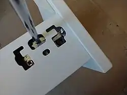 It also allows to remove the front. Insert a Philips screw driver in the +-shaped mechanism in the center opening (it is half hidden behind a small piece of metal which can be pushed up)…